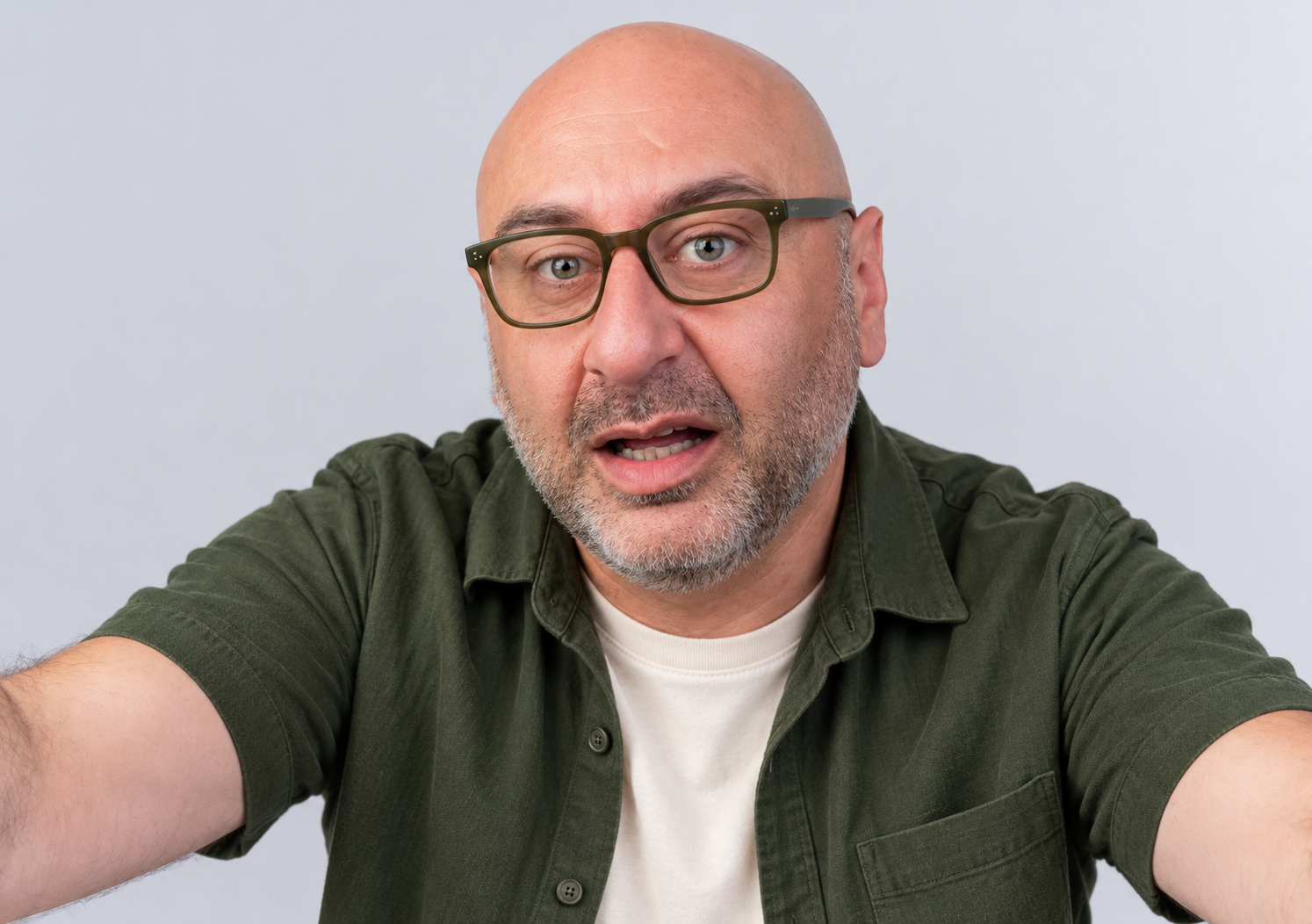 AI style preview of Ben with a shaved scalp, salt-and-pepper close beard, olive glasses and an open green short-sleeve shirt over an ecru tee.