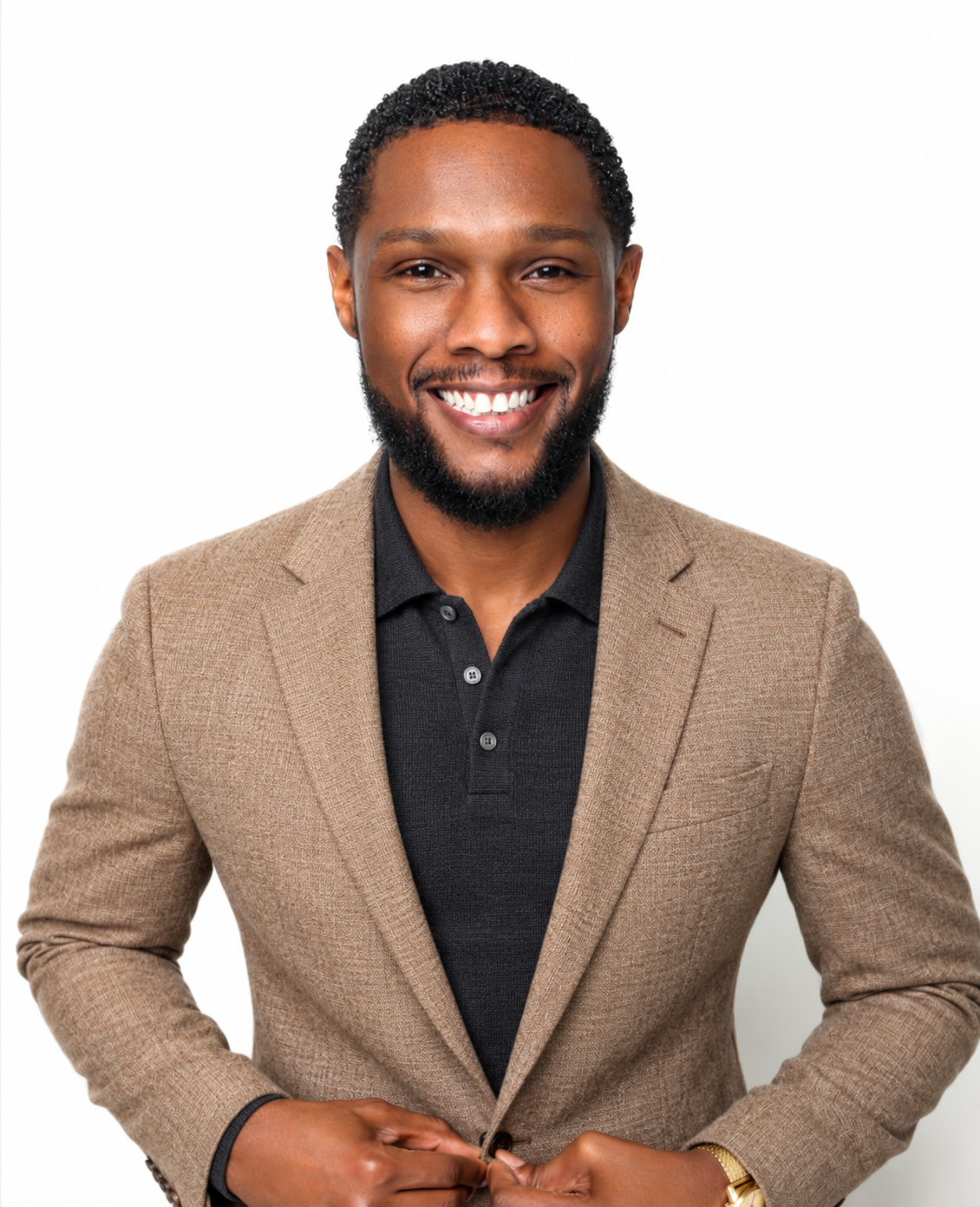 AI styling concept with a camel textured blazer, dark knit polo, short natural curls, a beard and hands near the jacket fastening.